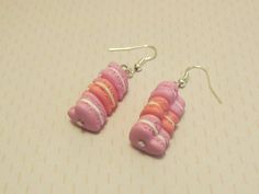 A pretty little pair of earrings representing little heart-shaped macaroons. Two are pink in color, and the third is salmon in color. Handmade from polymer clay. The buckles are silver metal. Length: 5cm. Width: 1.3 cm. Pendant height: 2.5 cm. Total weight of a loop: 3 grams. Sweet Pink Heart-shaped Earrings, Pink Heart-shaped Polymer Clay Earrings, Sweet Pink Polymer Clay Jewelry, Pink Polymer Clay Jewelry For Valentine's Day, Valentine's Day Pink Polymer Clay Jewelry, Cute Pink Polymer Clay Earrings, Pink Polymer Clay Earrings For Valentine's Day, Pink Kawaii Earrings For Valentine's Day, Kawaii Pink Earrings For Valentine's Day