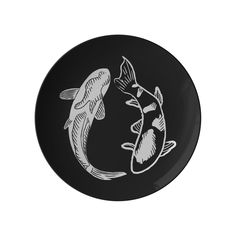 a black plate with two fish on it