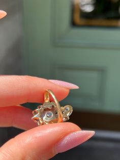 Playful yet elegant, this vintage Retro “Plume” Cluster Ring is a remarkable statement piece. Crafted circa 1940’s, this ring is a glimmering example of the ways 1940’s jewelry continued some of the Belle Epoque design traditions. Note the striking 14 carat yellow gold body of the ring, which juxtaposes beautifully against the 14 carat white gold top. Also beautiful are the cluster of vivid white miniature diamonds, which are arranged in a labyrinthine halo around the pièce de resistance – a gor Art Deco Diamond Cluster Ring With 17 Jewels, Art Deco Gold Cluster Ring With Rose Cut Diamonds, Vintage 14k Gold Jewelry With Center Stone, Antique Jewelry With Center Stone For Vintage Events, Art Deco Rings With Center Stone For Vintage Events, Art Deco Cluster Ring With 17 Jewels, Vintage Yellow Gold Diamond Jewelry, Vintage Style Bypass Ring As Gift, Vintage Yellow Gold Ring With Center Stone