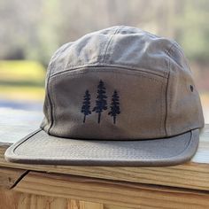 🌲🌲 5% of profits donated to preservation 🌲🌲  Gear up for your next adventure with our olive green tree 5 panel hat, the ultimate camp hat! Crafted from 100% cotton, this hat's flat bill keeps you cool and shaded as you conquer trails, lounge by the campfire, or explore the great outdoors. Your new adventure-ready essential! This hat is olive green with black embroidered trees on the front. Embroidery is custom designed by the shop owner, Alyssa, stitched on front. - 100% cotton - 5 Panel, Ca Military Style Baseball Cap With Short Brim, Casual Khaki Bucket Hat For Hiking, Khaki Military Bucket Hat For Outdoor Activities, Military Style Khaki Bucket Hat For Outdoor Activities, Military Style Khaki Bucket Hat For Outdoor, Adjustable Khaki Hat For Hiking, Military Snapback Hat With Flat Bill For Outdoor, Adjustable Khaki Hiking Hats, Military Style Green Bucket Hat For Outdoor