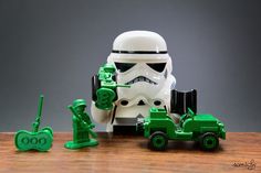 a toy stormtrooper and tractor on a wooden table next to it's driver