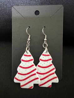 Handcrafted pair of adorable and lightweight earrings. Made of acrylic, stainless steel earring hooks with silicone earring stoppers included. Pendant image is double sided. Pendant measures approximately 1.25 inches x 1.75 inches. Dangle is approximately 2.75 inches. Listing is for 1 pair of earrings. Thank you for shopping with me. White Ear Wire Earrings For Holiday, White Holiday Earrings With Ear Wire, Nickel-free White Earrings For Christmas, White Festive Christmas Earrings, White Christmas Festive Earrings, Festive White Earrings For Christmas, Tree Earrings, Christmas Tree Earrings, White Christmas Tree