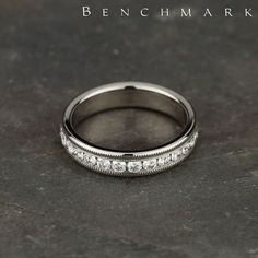 This elegant 4mm channel set eternity band features 26 round ideal-cut diamonds along the center with milgrain. Total approximate carat weight is 1.04ct. | 534550W | #benchmarkrings #ring #rings #diamonds #diamond #fiance #weddingring #bling #wedding #gold #gettingmarried #theknot #shesaidyes #jewelry #engaged #engagementring #marryme #fashion #mensfashion #love #style #madeinamerica #beautiful #bride #groom #luxury #art #lovestory #womensfashion #engagement Classic Diamond White Channel Set Eternity Band, Classic Diamond White Eternity Band With Channel Set, Diamond White Eternity Band With Channel Set Diamonds, White Gold Diamond Eternity Band With Channel Set, Classic Channel Set Diamond White Eternity Band, Classic Diamond Eternity Band With Channel Set, Diamond White Eternity Band With Channel Set, Timeless Diamond White Channel-set Eternity Band, Timeless Diamond White Eternity Band With Channel Set