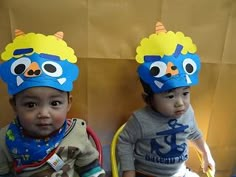 two small children wearing matching hats on their heads