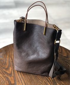 "A comfortable SMASLL size bag. The bag is made with brown genuine cow leather.  It is not  lined. It has canvas removable pockets bag inside. The handles are made with tan leather, attached to the bag with metal hardware. You'll get with the bag a removable' adjustable leather shoulder strap and a messenger removable adjustable webbing strap. 100% real leather. Measurements: Handles: 4\" (10 cm) drop. Height: 11\" (28 cm) Width: 9 1/2\"  (24 cm) at the top. Width: 7\"  (17 cm) at the bottom. De Retro Nature, Cowhide Handbags, Retro Handbags, Everyday Tote Bag, Soft Leather Bag, Genuine Leather Totes, New Retro, Woman Bags Handbags, Genuine Leather Bags