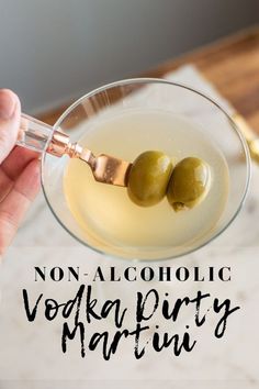 two olives in a martini glass with the words non alcoholic vodka party martini on it