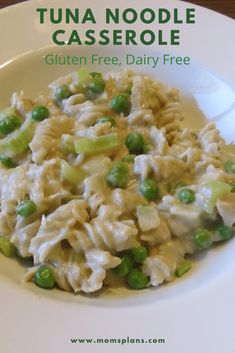 a white plate topped with pasta and peas