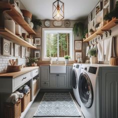 a washer and dryer in a small room with open shelves on the wall