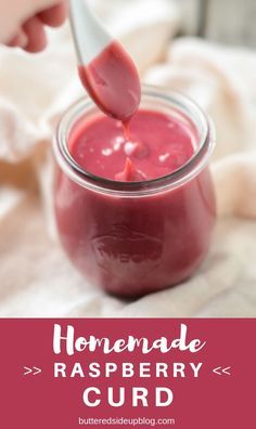 homemade raspberry curd in a glass jar with a spoon and text overlay reading homemade raspberry curd