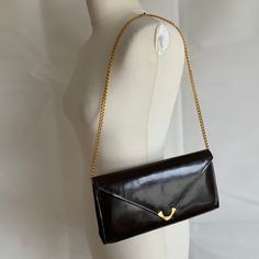 Gorgeous quality very dark brown patent leather leather clutch bag with a Long chain shoulder strap. 1970s , leather with leather lining and an inside mirror pocket ( mirror not included). Good front catch and in very good vintage condition inside and out. A small scratch on the front flap ( see photos). 27 x 14 x 5 cm. From a selection of vintage accessories and clothes at Coolclobber https://www.etsy.com/uk/shop/cool-clobber Retro Brown Clutch For Evening, Elegant Vintage Brown Shoulder Bag For Evening, Classic Brown Evening Bag For Formal Occasions, Classic Brown Formal Evening Bag, Vintage Brown Bag With Chain Strap, Brown Evening Bag With Chain Strap, Elegant Brown Evening Bag With Chain Strap, Vintage Brown Clutch For Party, Vintage Formal Clutch With Chain Strap