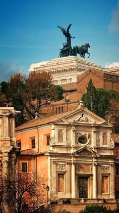 an old building with statues on top