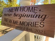 a wooden sign that says, new home news beginning new memories