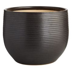 a large black bowl sitting on top of a table