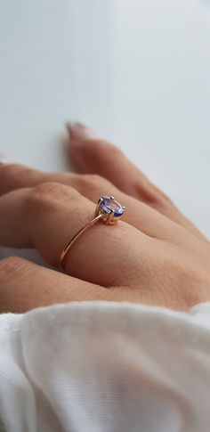 RING DETAILS: ✪Design: Gold ring ✪Gemstone: Natural tanzanite ✪Gemstone shape: Oval ✪Gemstone size: 4x6 mm ✪Gemstone weight: 0.45 ct ✪Gold weight: 1.1 grams ✪Setting type: Prong setting ✪Metal type: 14k solid gold ✪Metal finish: Smooth shiny Choose your ring size from drop down menu and if you need any other preferred ring size please contact us. QUALITY OF MATERIALS: Metal: Most of our jewelry at JewelryMansion is made with precious metals like gold and silver. These metals are 100% non-allergi Fine Jewelry Yellow Gold Tanzanite Rings, Tanzanite Sapphire Ring As Gift, Tanzanite Birthstone Ring In Fine Jewelry Style, Fine Jewelry Tanzanite Birthstone Ring, Tanzanite Yellow Gold Birthstone Ring As Gift, Yellow Gold Tanzanite Birthstone Ring For Gift, Tanzanite Gemstone Rings In Yellow Gold, Yellow Gold Tanzanite Gemstone Rings, Gift Sapphire Ring With Tanzanite Birthstone