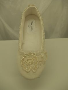 a pair of women's shoes with beading and pearls on the soles