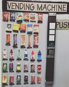 a vending machine filled with lots of different types of snacks and drinks next to a sign