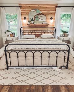 a bedroom with a metal bed frame and white pillows