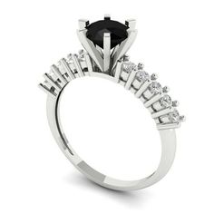 a black diamond engagement ring with white diamonds on the shoulders and side stones, set in 18k white gold