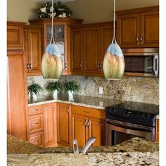 a kitchen with granite counter tops and wooden cabinets, along with stainless steel stove top oven