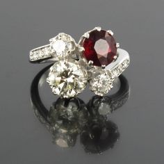 This is part of Chairish’s Fine Jewelry assortment.  Ring in 18 karat white gold, eagle's head hallmark.  Featuring a claw set round ruby and a brilliant- cut diamond, another smaller diamond is set at each side with a further 3 small diamonds leading into the ring band on each side.  Ruby Weight : 2.04 carat approximately Weight of the center diamond: 1.26 carat approximately Total weight of other diamonds : approximately 0.65 carats.  The estimated quality of the diamond is G-H / VS.  US Size Engagement Ring Size, Eagle Head, Engagement Ring Sizes, Ruby Diamond, Brilliant Cut Diamond, Cocktail Rings, Ring Shopping, Hallmark, Floral Rings