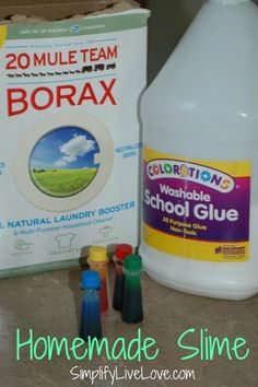 two bottles of borax sitting on top of a counter next to some crayons