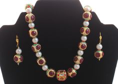 Product details: Necklace Set - Enameled in White and Red Dimensions : lenght 18" Material Used : copper and Alloy This is a elegant, ravishing micro gold plated designer mughal style kundan meenakari necklace set with matching earrings.This neckpiece is very light weight and has a scratch resistant coating. This necklace set will remain in its original glory for years. This necklace set is handcrafted and handmade. The neclace is enamelled with meenakari work and kundan stones are studded in it Formal Meenakari Jewelry Sets For Diwali, Multicolor Round Jewelry With Zari Work, Round Meenakari Necklaces For Eid, Meenakari Necklaces For Eid, Festive Multicolor Zari Work Jewelry, Formal Meenakari Temple Necklace For Diwali, Multicolor Jewelry Sets For Puja And Festive Occasions, Multicolor Festive Jewelry Sets For Puja, Festive Multicolor Jewelry Sets For Puja