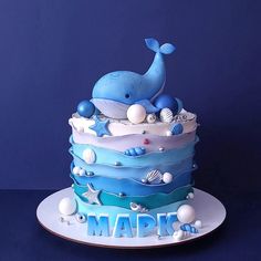 a blue and white cake with a whale on top