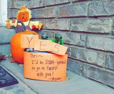 an orange sign sitting on the side of a building next to a pumpkin and other items