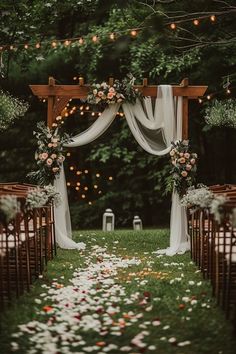 an outdoor ceremony set up with flowers and greenery