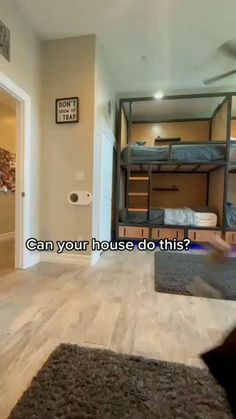 a room with bunk beds and an open door that says can your house do this?