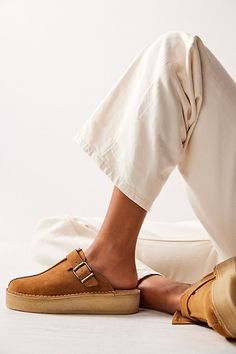 An effortless everyday pair, these mules from Clarks feature premium suede uppers, sat on a slightly wedged platform crepe sole with a buckle and fob detail for added accents. **Features:** Slip-on style, backless design, round toe, suede uppers, center seam, buckle detail, attached fob, slight wedge, platform crepe rubber sole **Why We | Clarks Trek Wedge Mules at Free People in Tan, Size: US 9 Womens Fall Shoes Casual, Temporary Wardrobe, Rich Girl Fashion, Wedge Mules, Online Closet, Backless Design, Clarks Originals, Womens Clarks, Desert Boots