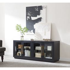 a living room with a couch, chair and bookcase on the floor in front of a painting