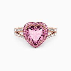 a pink heart shaped ring with diamonds around it