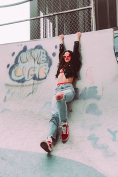 a woman is laying down on a skateboard ramp