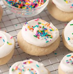 frosted donuts with sprinkles on a cooling rack