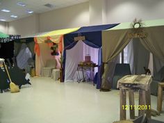 a room filled with lots of different colored tents