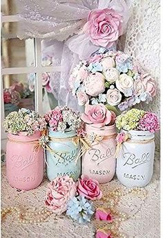 pink and blue mason jars with flowers in them