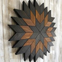 a wooden wall hanging on the side of a building