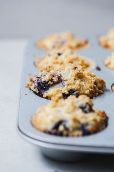 blueberry muffins sitting in a muffin tin