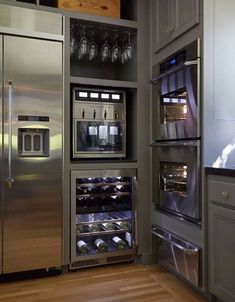 a stainless steel refrigerator and freezer combo in a kitchen with wood floors, cabinets and drawers