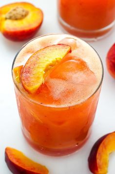 an orange drink garnished with sliced peaches