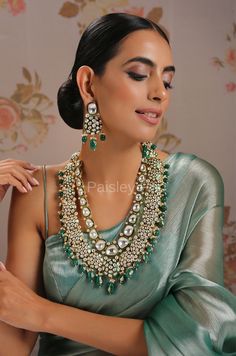 The majestically handcrafted green Polki necklace set is an ode to the Indian tradition and intricate work handcrafted by the artisans of India. The green meenakari work with shell pearls is a masterpiece inspired by Sabyasachi jewelry to give you a royal look. The bold and bright design of the necklace is perfect for all the beautiful brides to be! Pair this replica of an ancestral jewelry necklace set with your ethnic or contemporary ensembles and create a look to remember. Necklace Closure - Luxury Meenakari Necklaces For Designer Wear, Pista Green Jewellery Set, Elegant Green Zari Work Kundan Necklace, Festive Green Meenakari Jewelry, Heavy Green Temple Necklace, Elegant Green Necklace With Zari Work, Traditional Green Meenakari Jewelry, Elegant Green Cutdana Jewelry, Green Meenakari Jewelry For Celebration