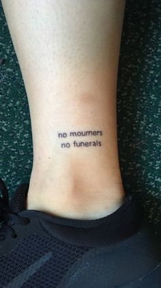 a woman's foot with a tattoo that reads no monuments, no funerals