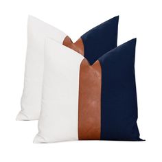 two white and blue pillows with brown leather trims on each pillow, side by side