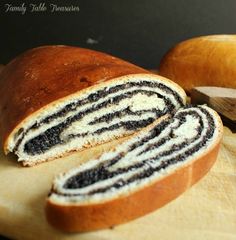 a loaf of black and white swirl bread on a cutting board next to an apple