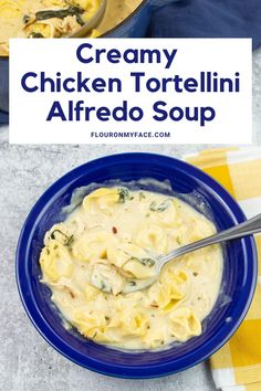 creamy chicken tortelli alfredo soup in a blue bowl with a spoon on the side