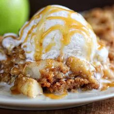 an ice cream sundae with caramel drizzle and apples on the side