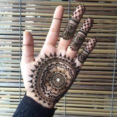 a hand with henna tattoos on it