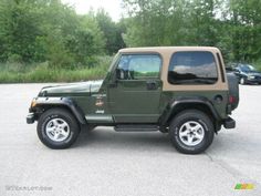 a green jeep parked in a parking lot