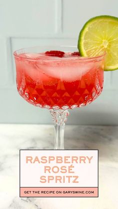 raspberry rose spritz in a coupe glass with a lime slice on the rim